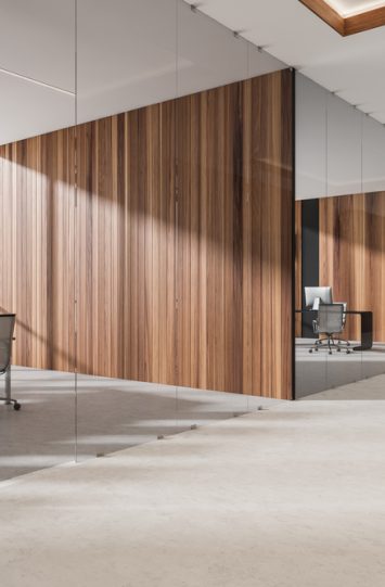 Corner view on bright office room hall interior with panoramic window, desktop, comfortable armchairs, desk and concrete floor. Perfect place for working process. Minimalist design. 3d rendering